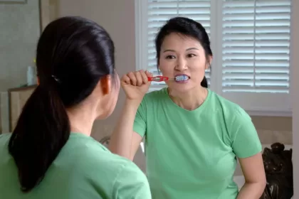 Women brush teeth