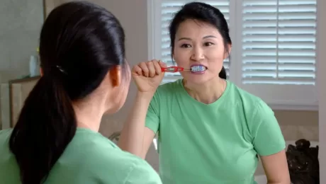 Women brush teeth